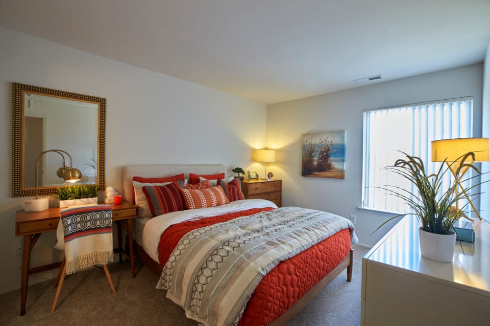 Model bedroom with plush carpeting and plenty of natural lighting at Lakeside Terraces in Sterling Heights, Michigan